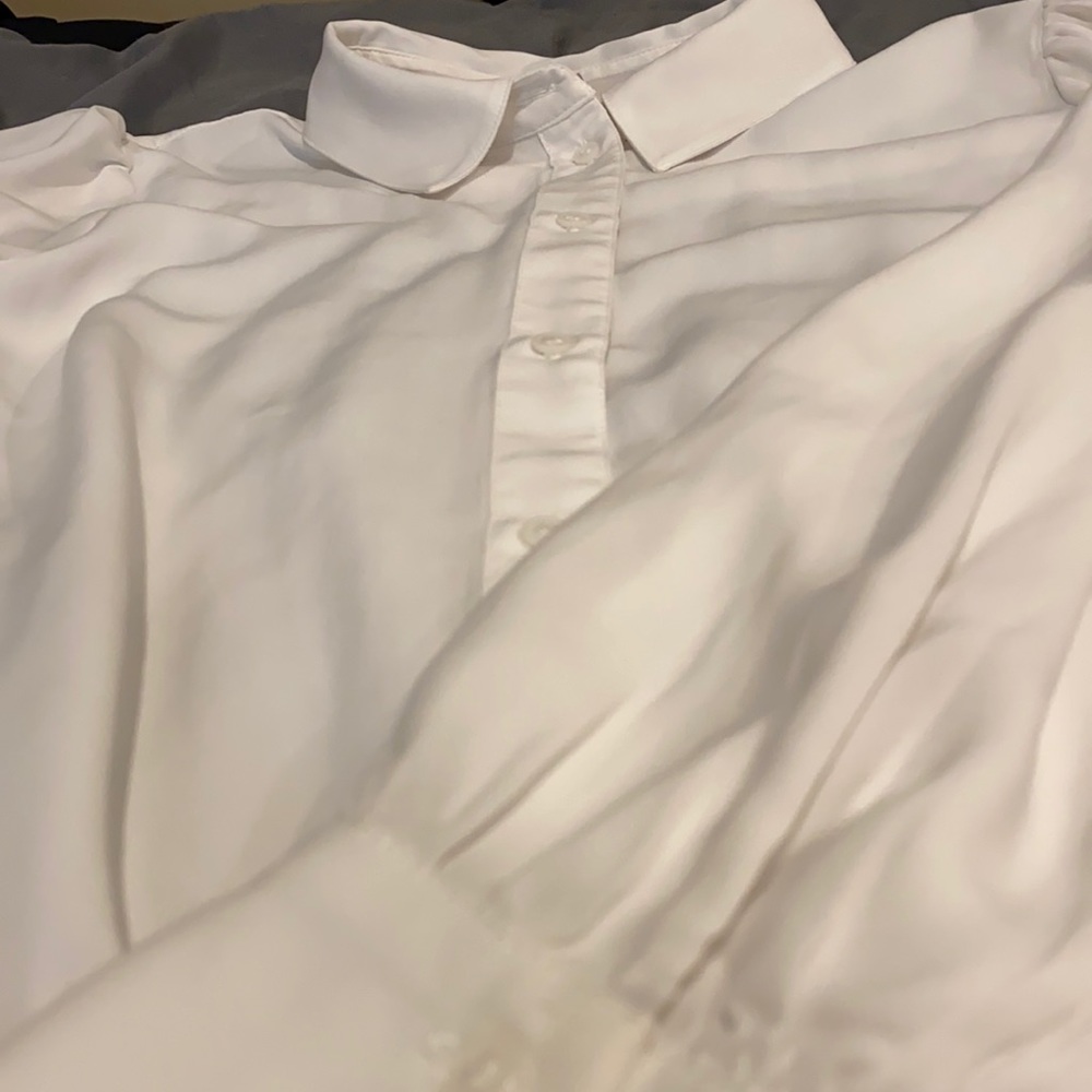 Women’s white pillow sleeved dress shirt.